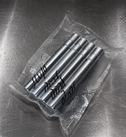 Set of metal stamps with engraved text on a metallic surface